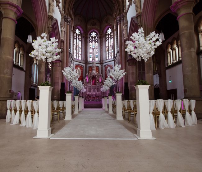 White Blossom Tree Lined Wedding Ceremony Monastery Chair Drapes White Carpet Stunning Venue