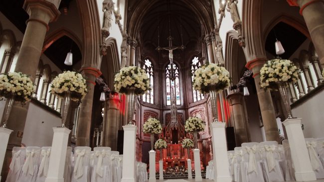 Stunning Flowers for Wedding at Monastery Manchester White Chair Covers & Cream Taffeta Bows White Carpet Silver Vases