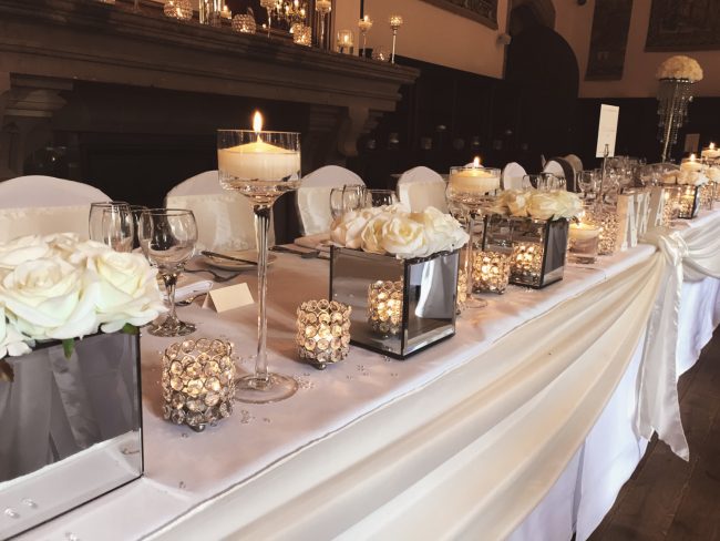 Top Table Flowers and candles with Cream Taffeta Table Swag
