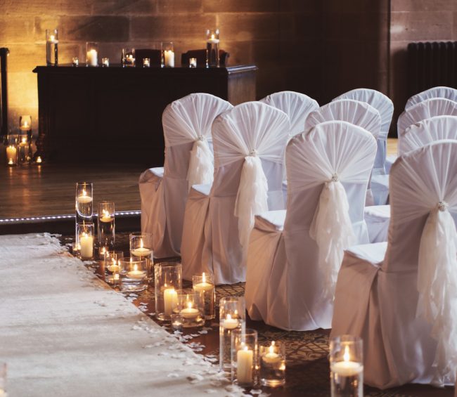 Ruffle Hood chair decor with floating candles lining aisle